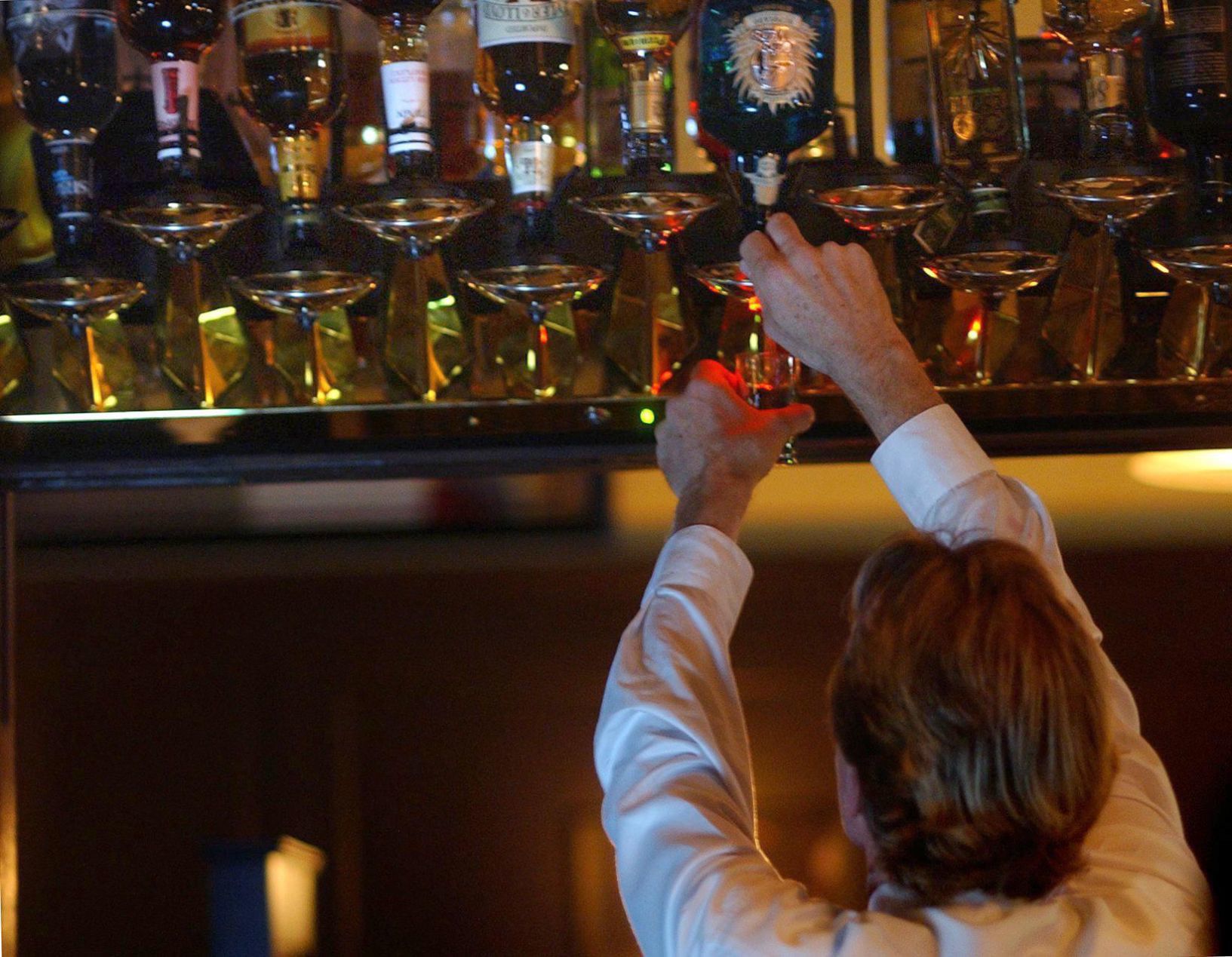 Bartender draws liquor